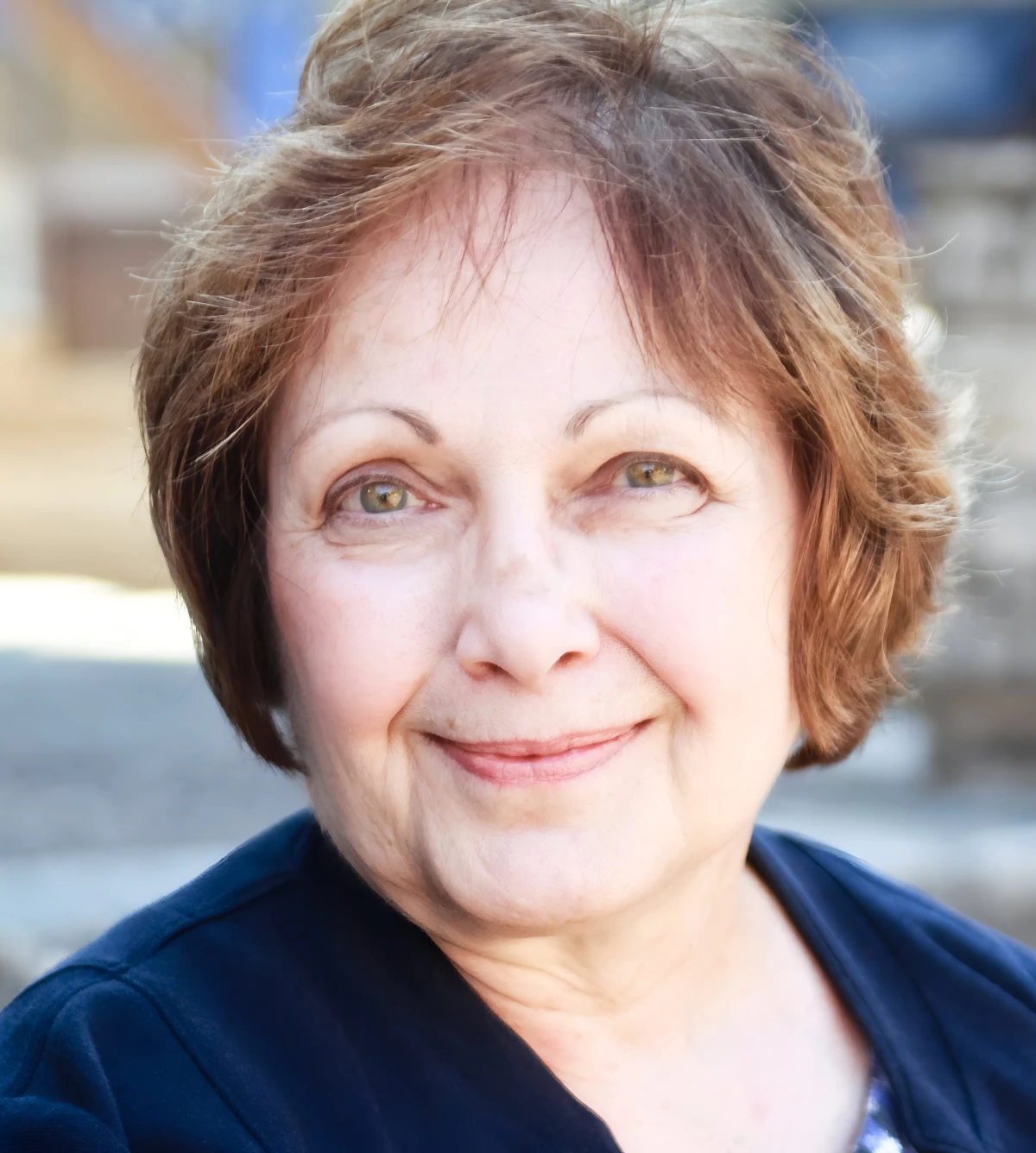 Smiling woman with short brown hair.